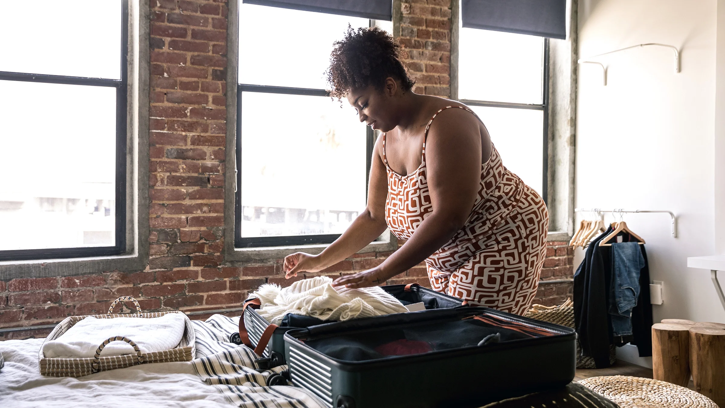 Woman packing a suitcase.
