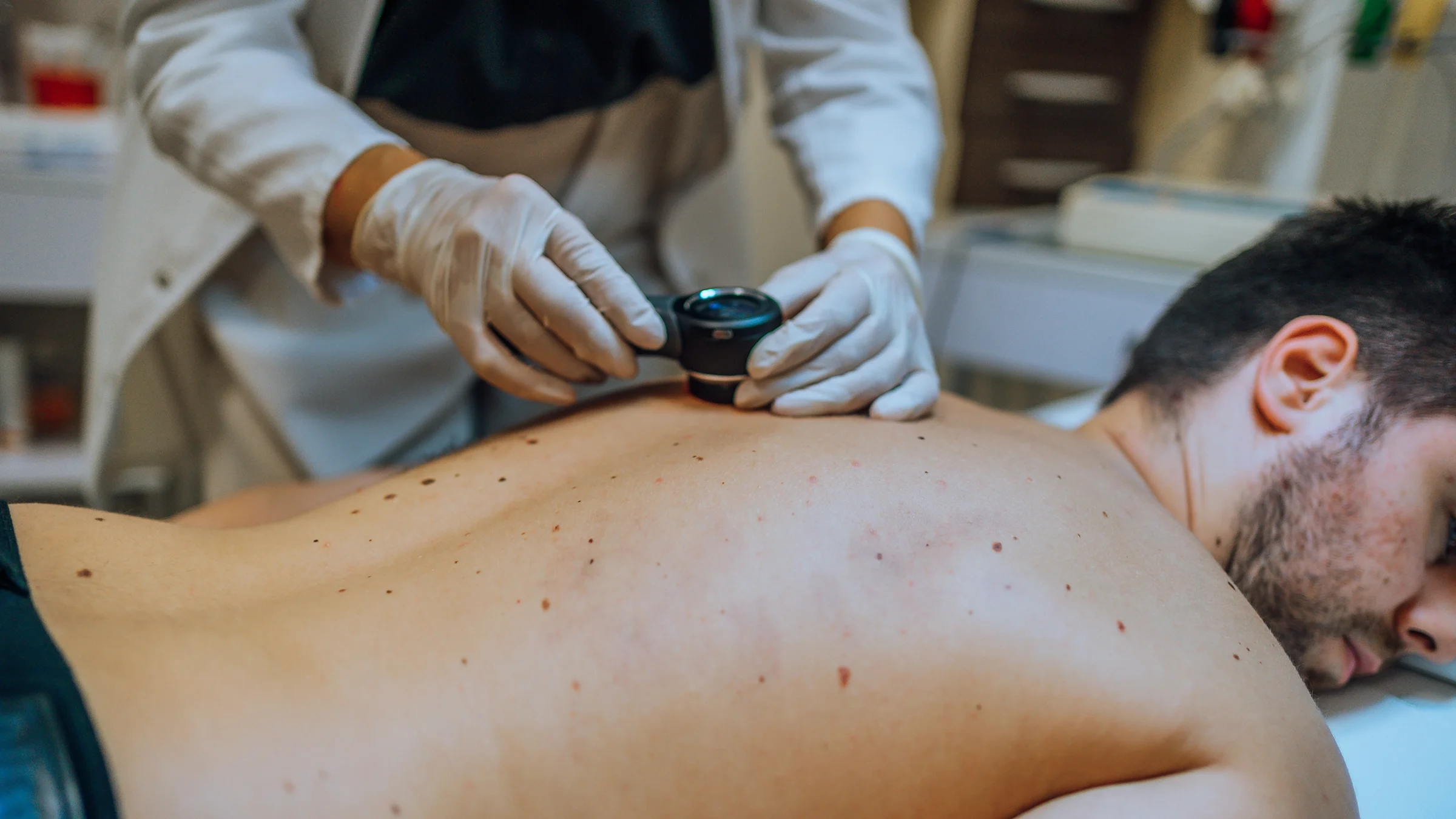 Dermatologist inspecting patient's skin