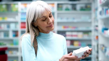 Antihistamines: woman reading box of medication 2180483223