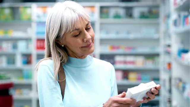 Antihistamines: woman reading box of medication 2180483223