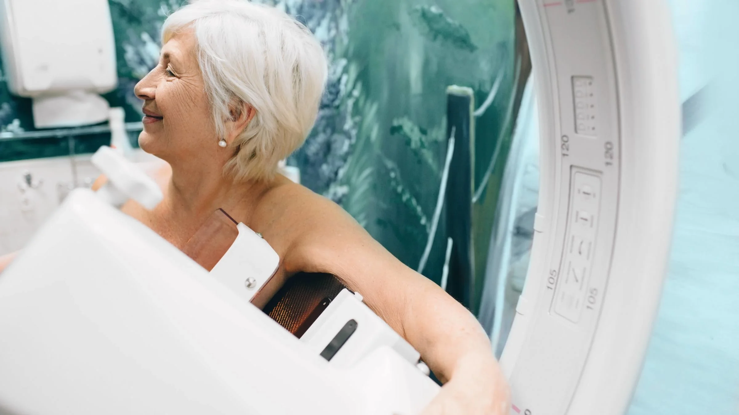 An older adult getting a mammogram.