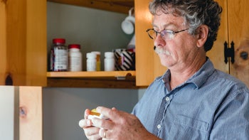Health: Fentanyl: man reading Rx bottle 1497331906