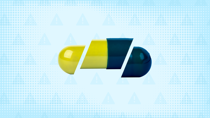 In the center of a light blue background with texture and warning sign pattern is a lime green and navy blue capsule pill cut into thirds.