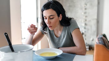 Diet Nutrition: woman eating soup 1147152535