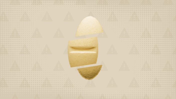 In the center of a cream-colored background with a texture and warning sign pattern, is an oblong cream-colored pill sliced into thirds. 