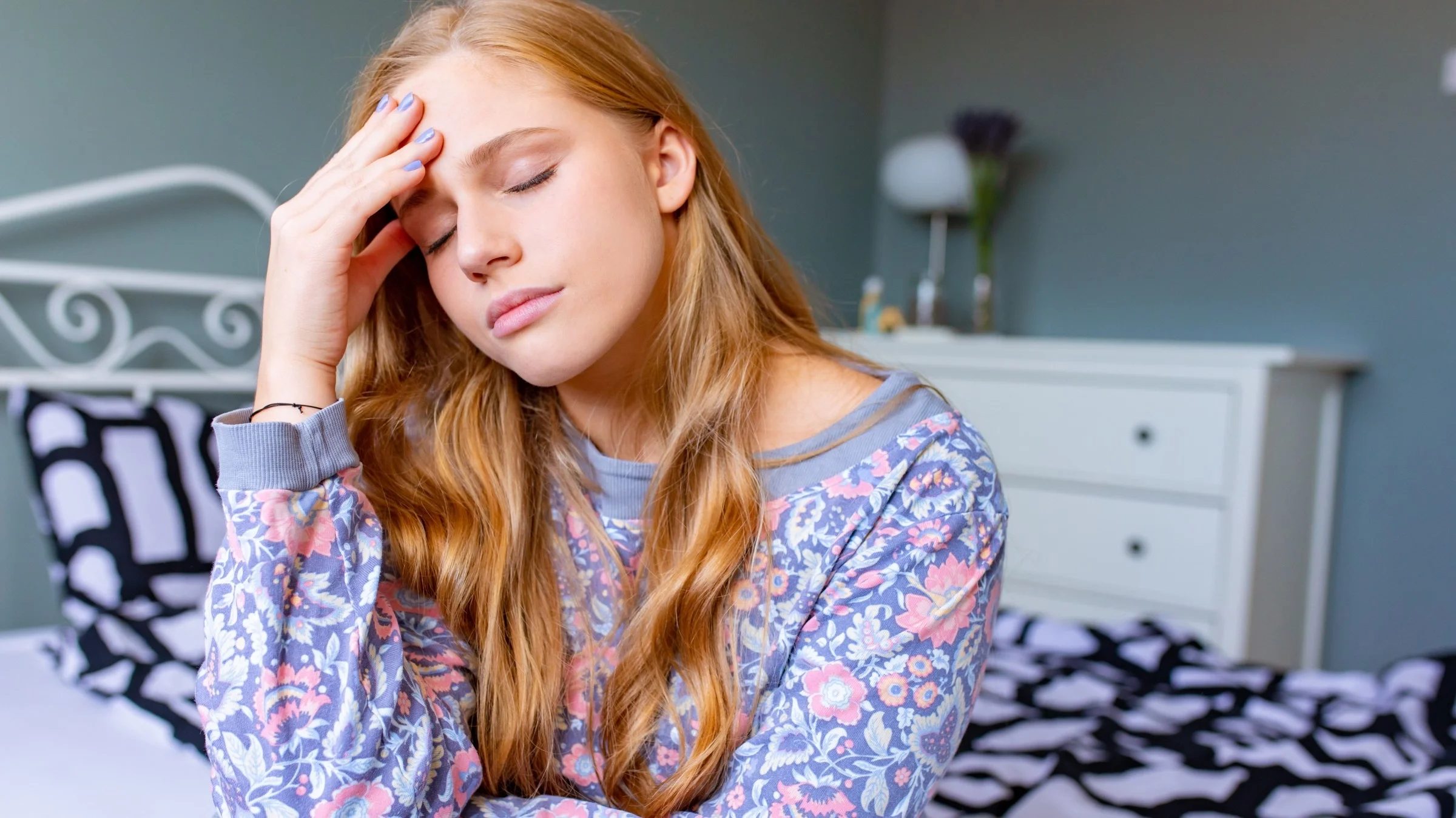 A stressed out person holding their head in pain.