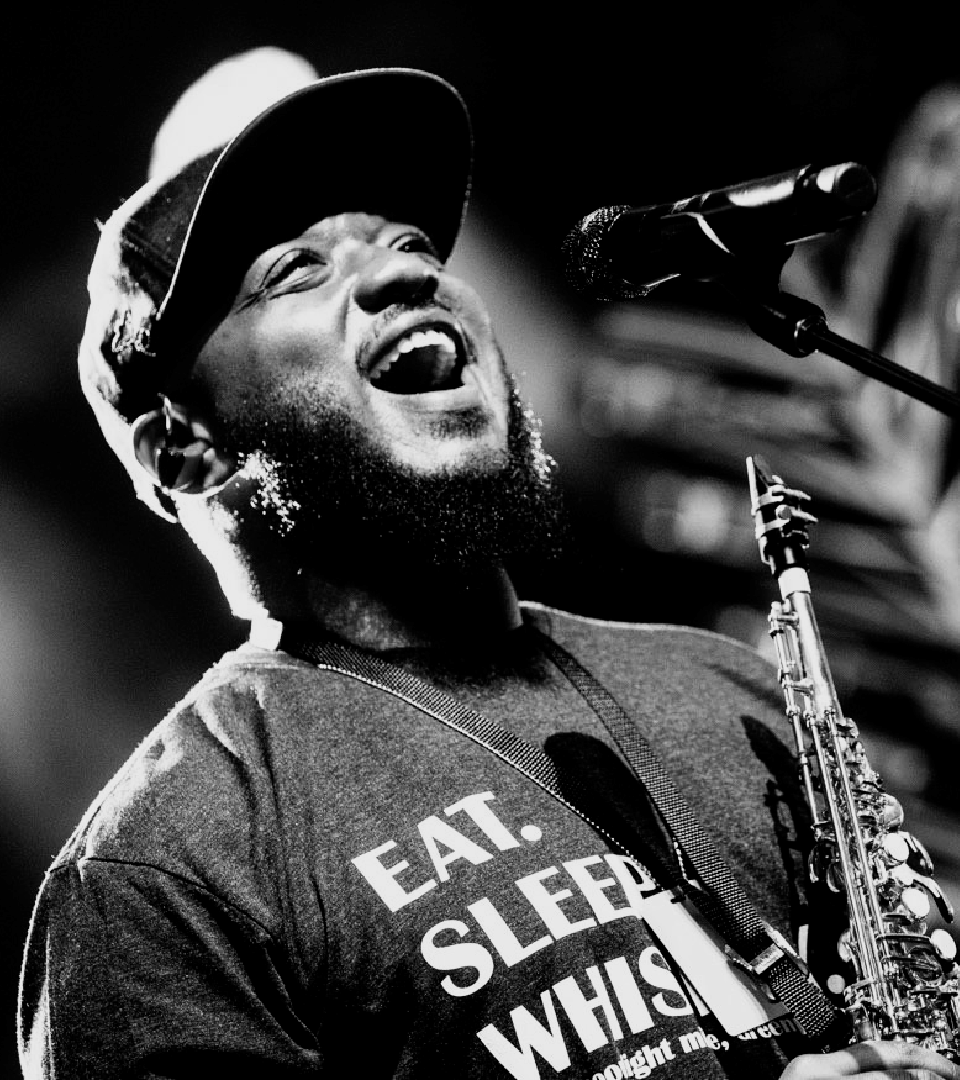 Black and white photo of James Casey playing the saxophone on stage. 
Photo courtesy of Rene Huemer
