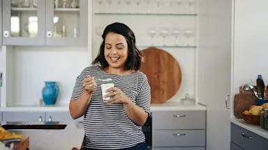 Health: Gut health: woman eating yogurt 892674098