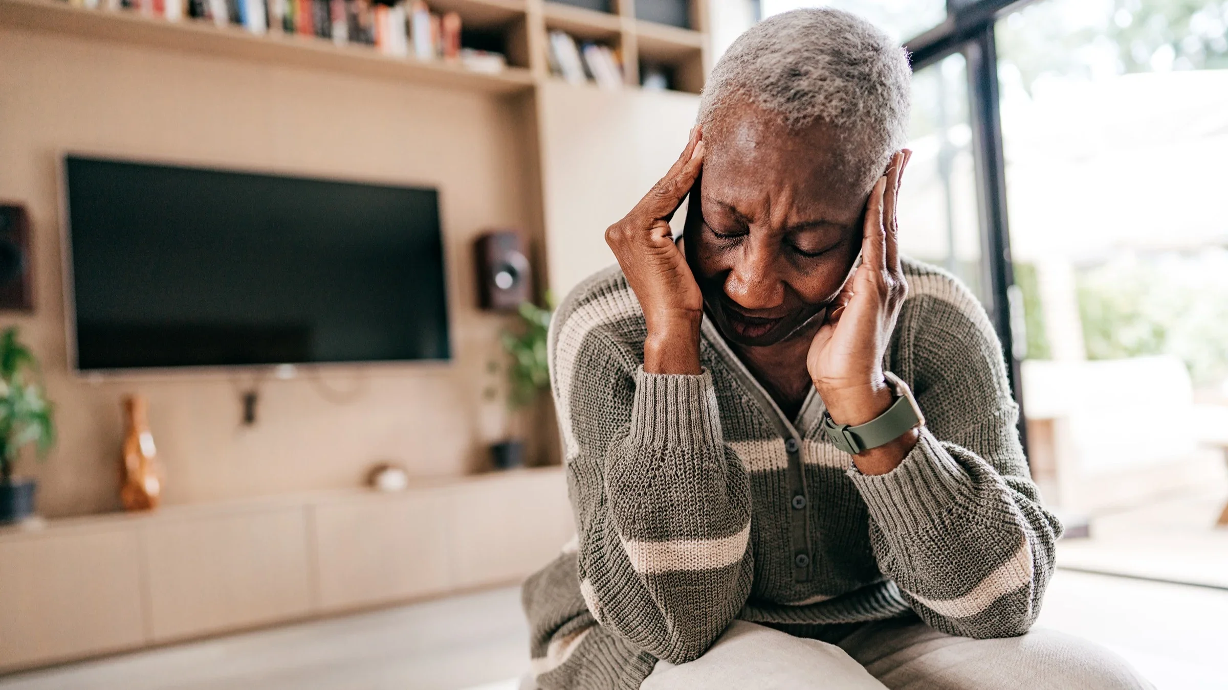 Health: older woman feeling headache pain 1270092167