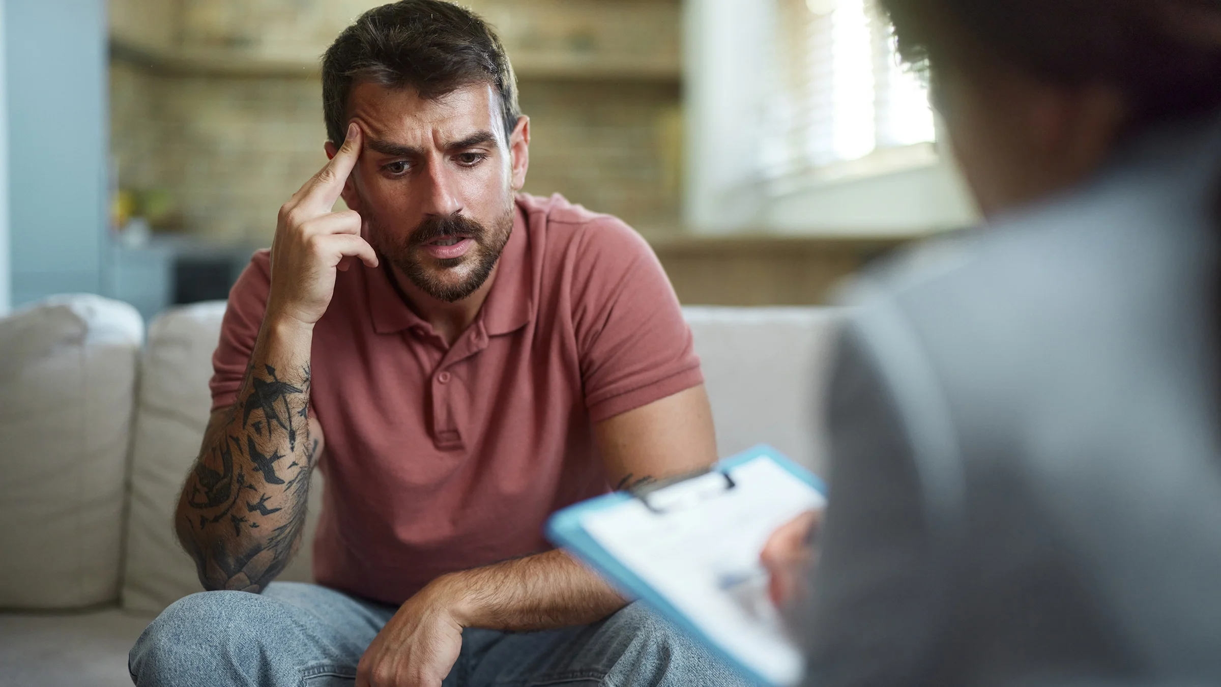 A man sitting during a therapy session.