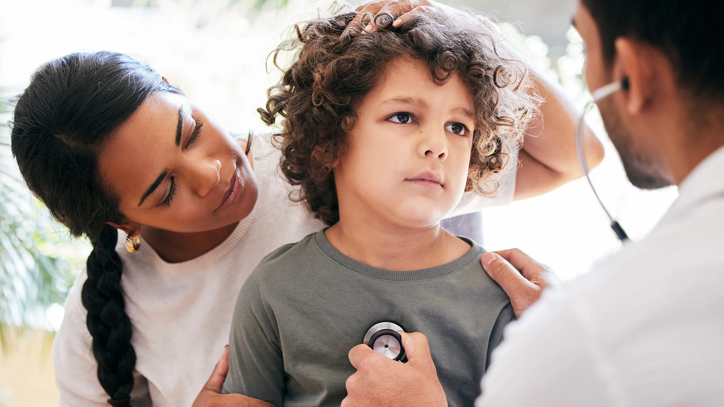 Doctor checking child's breathing with stethoscope