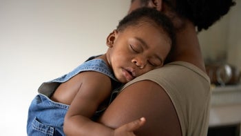 Children's health: Sleep regression: mom holding sleeping baby-84142920