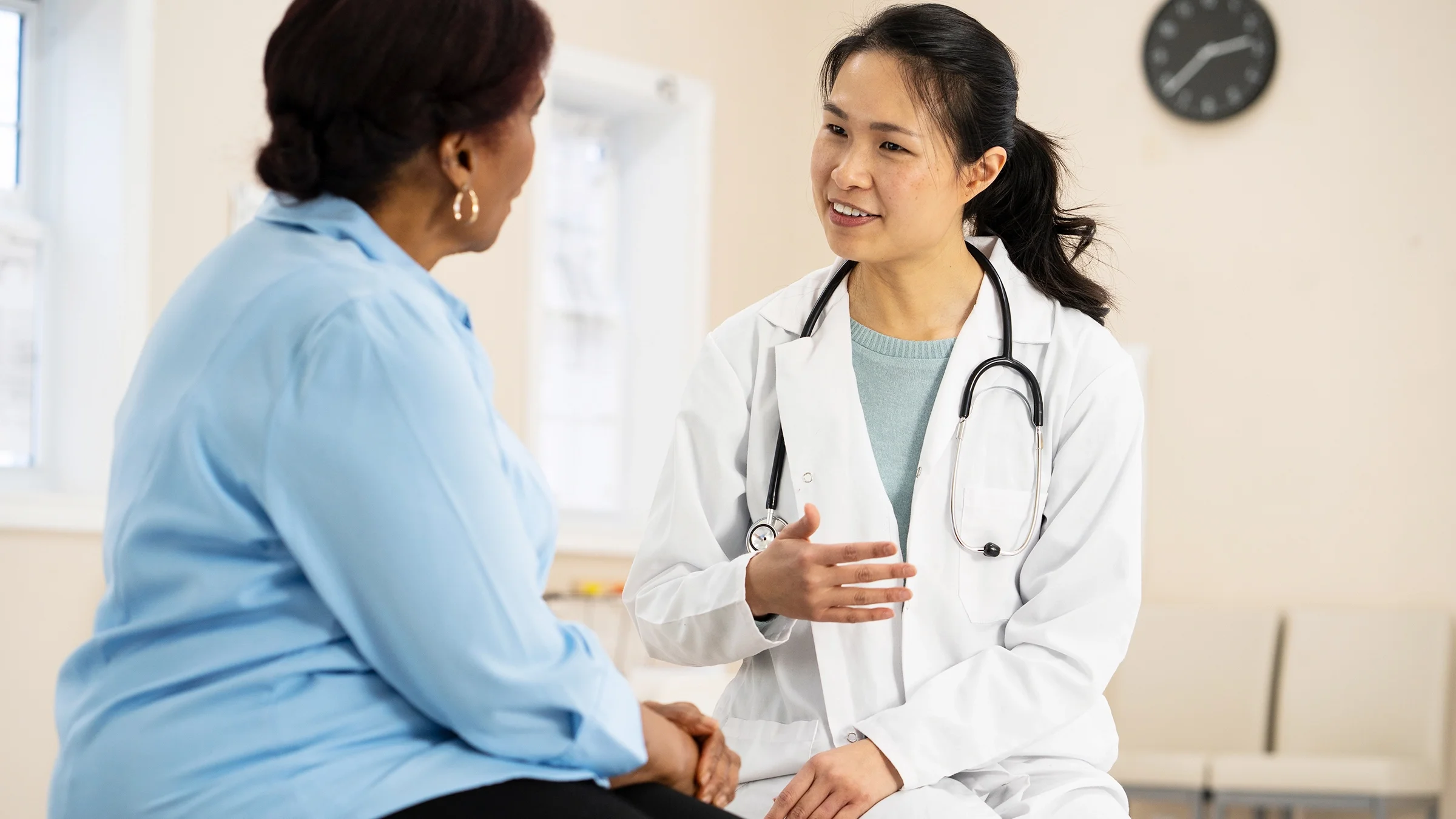 A senior woman talks with her doctor.