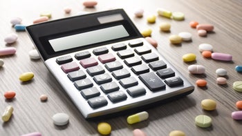 Drug cost savings: calculator surrounded by pills 1371572114