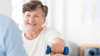 Health: Stroke: senior woman lifting weights 950649706