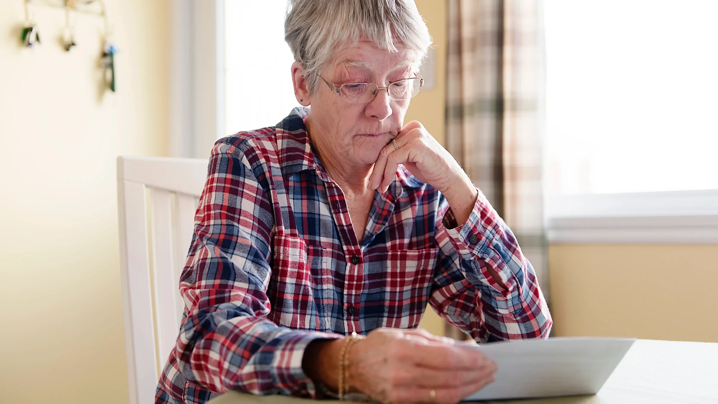 A woman reviews paperwork.