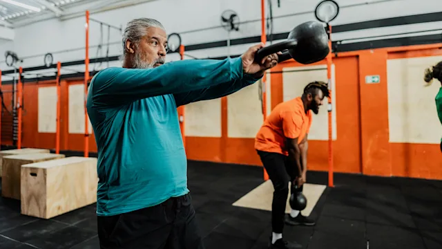 Weight-loss: adult man kettlebell swing exercise 2149170256