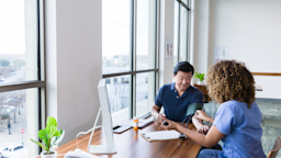 Medical professional checks senior man's blood pressure during a medical appointment.
SDI Productions/E+