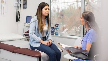 fertility: woman at medical appointment 2099564017