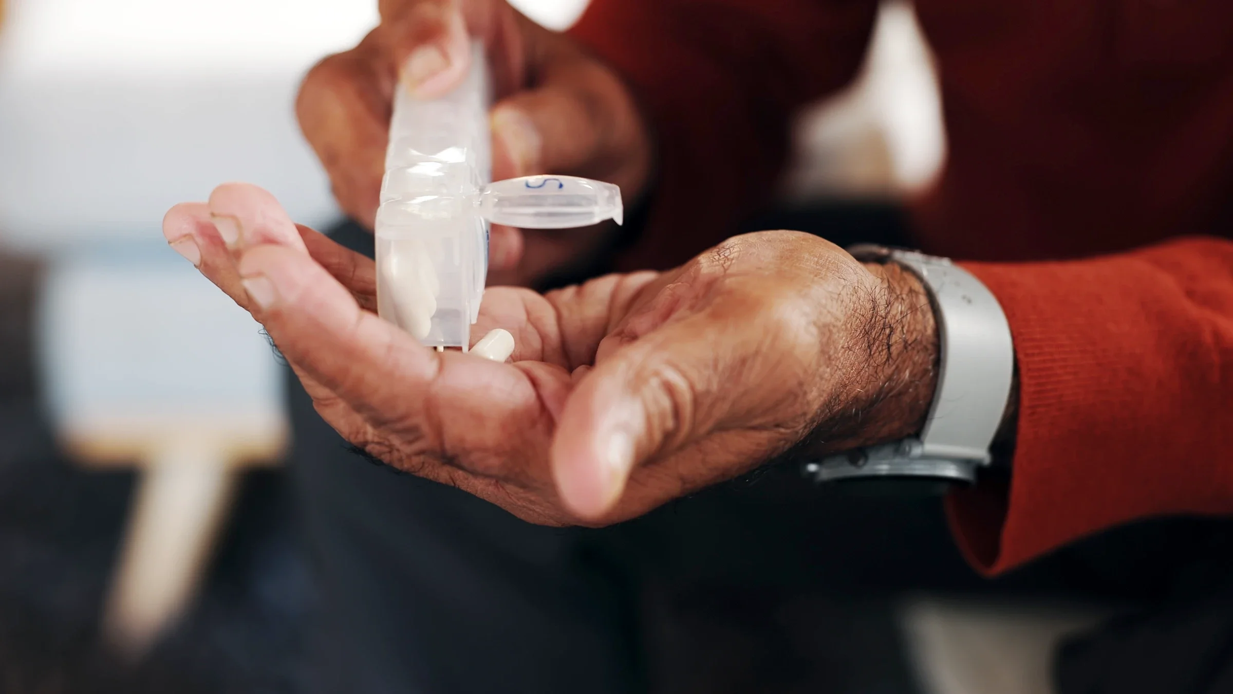 Close-up pill organizer in hands.