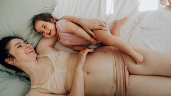 Parenthood Pregnancy: Cesarean section: parent with c-section scar cudding with baby-1324871890