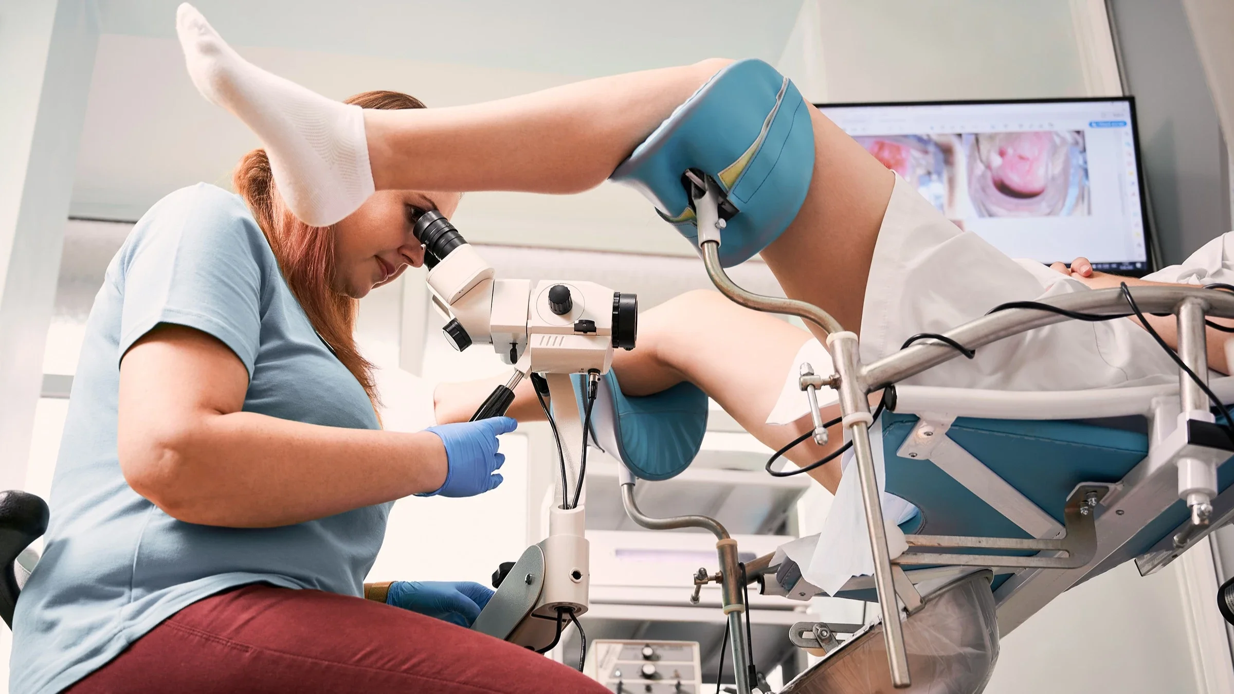 Woman in the exam stirrups having a gynecologist examine her.