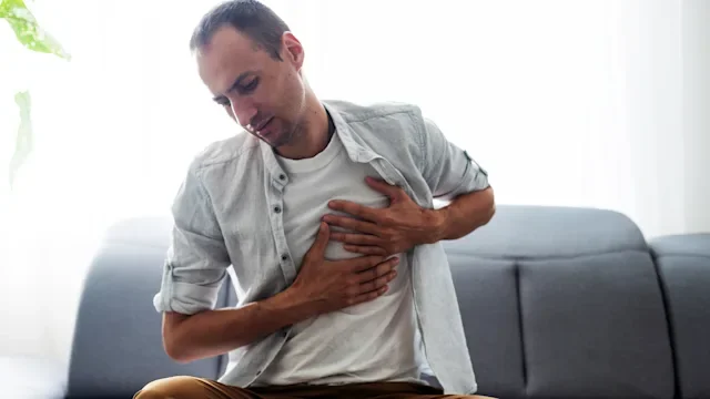 Health: mental health: man in pain sitting on couch 1412417540