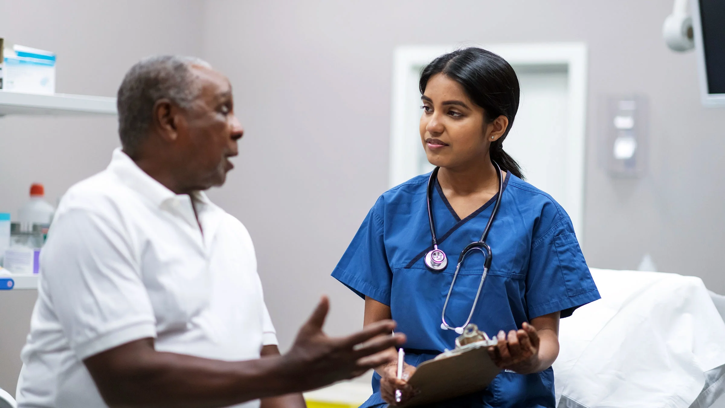 A senior man consults with his doctor during a healthcare appointment.