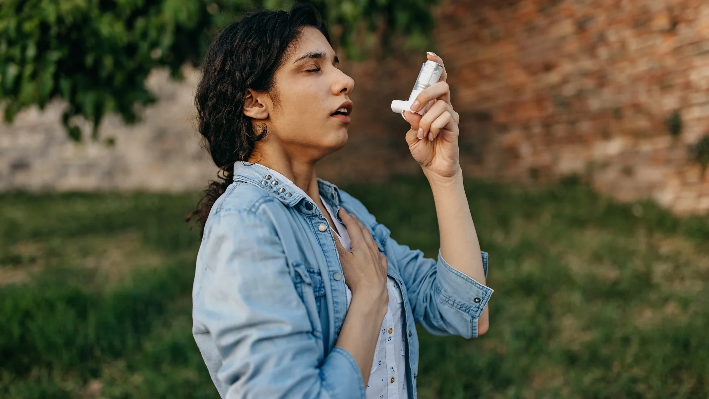 A person with allergies using an inhaler.