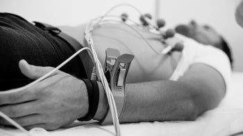 man laying down for EKG test 1303647632