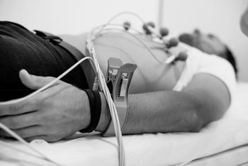 man laying down for EKG test-1303647632