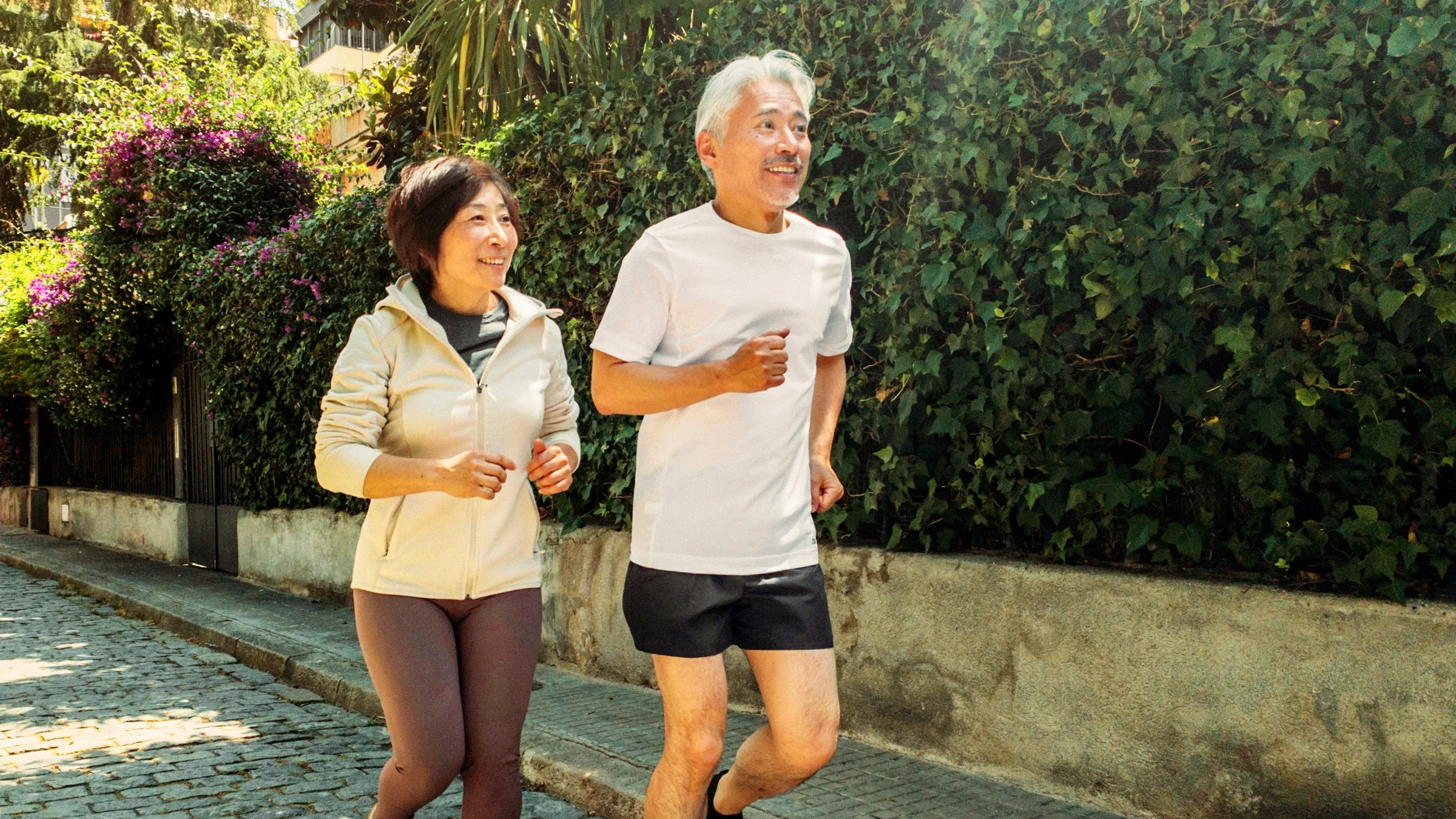 An older couple running together.