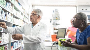 spiriva respimat: pharmacist grabbing medication for customer 1171965934