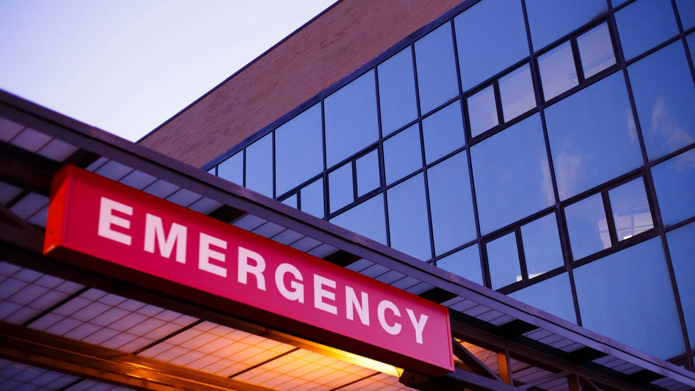 Red emergency room sign on the front of a building.