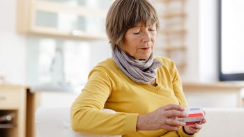 Health: Furosemide: senior woman reviewing medication package-174779783