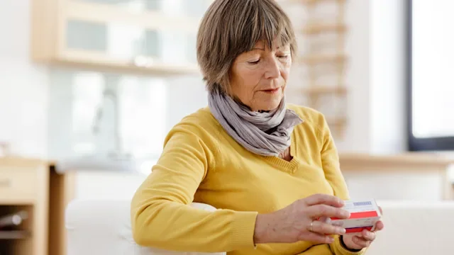 Health: Furosemide: senior woman reviewing medication package-174779783