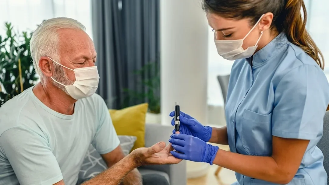 A nurse checking a patient's blood sugar.