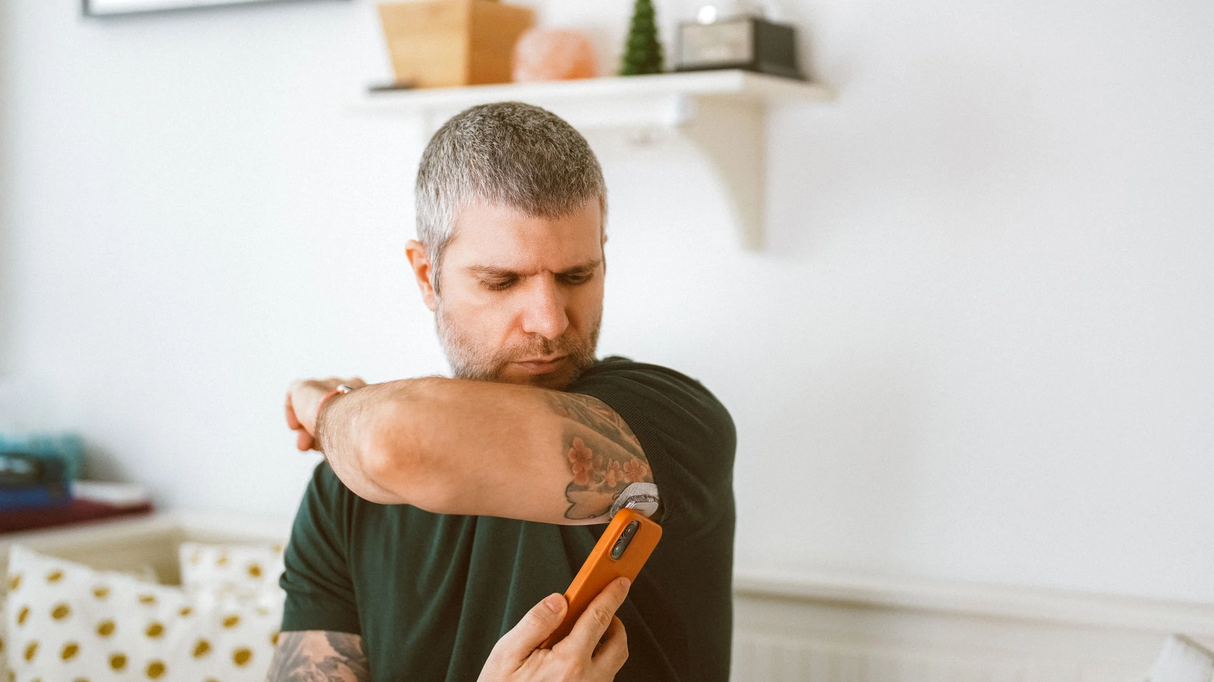 An adult is doing a glucose test at home via a phone app.