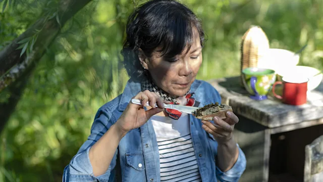 Health: Diet and nutrition: woman eating plant based snack 1390051489
