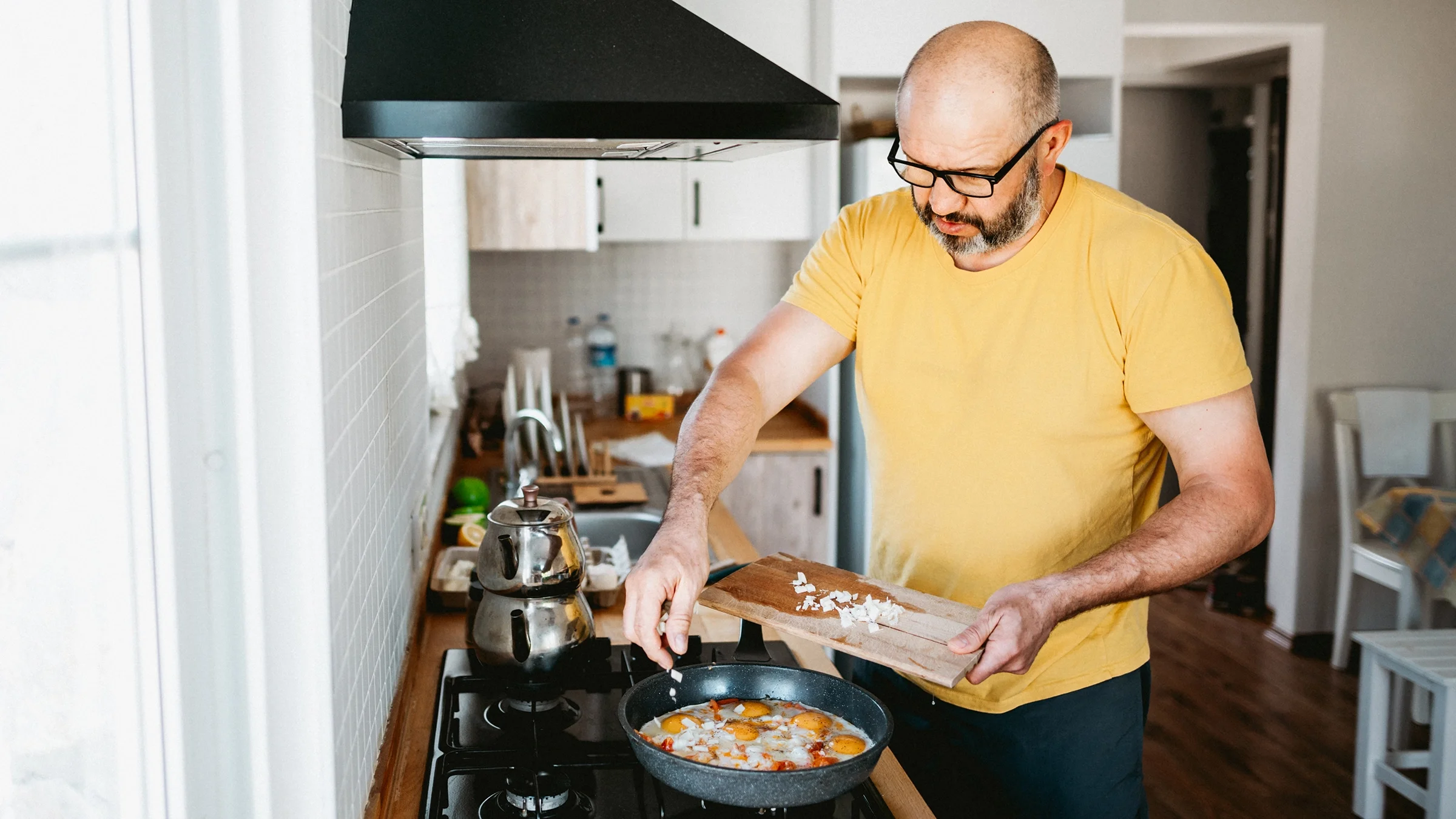 Man cooking fried eggs