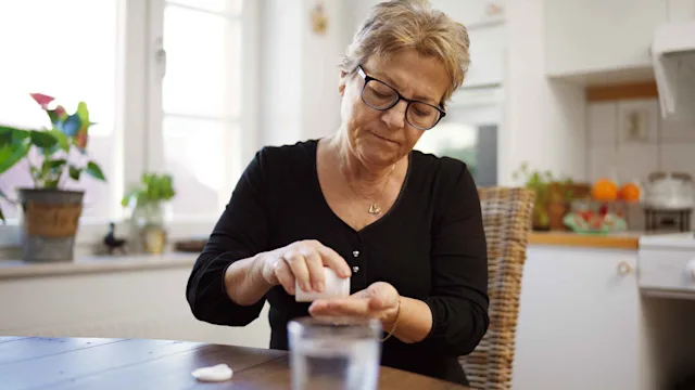 Health: Singulair: woman taking medication 1300285966