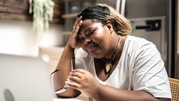 Research: concerned woman looking at laptop 1304401244