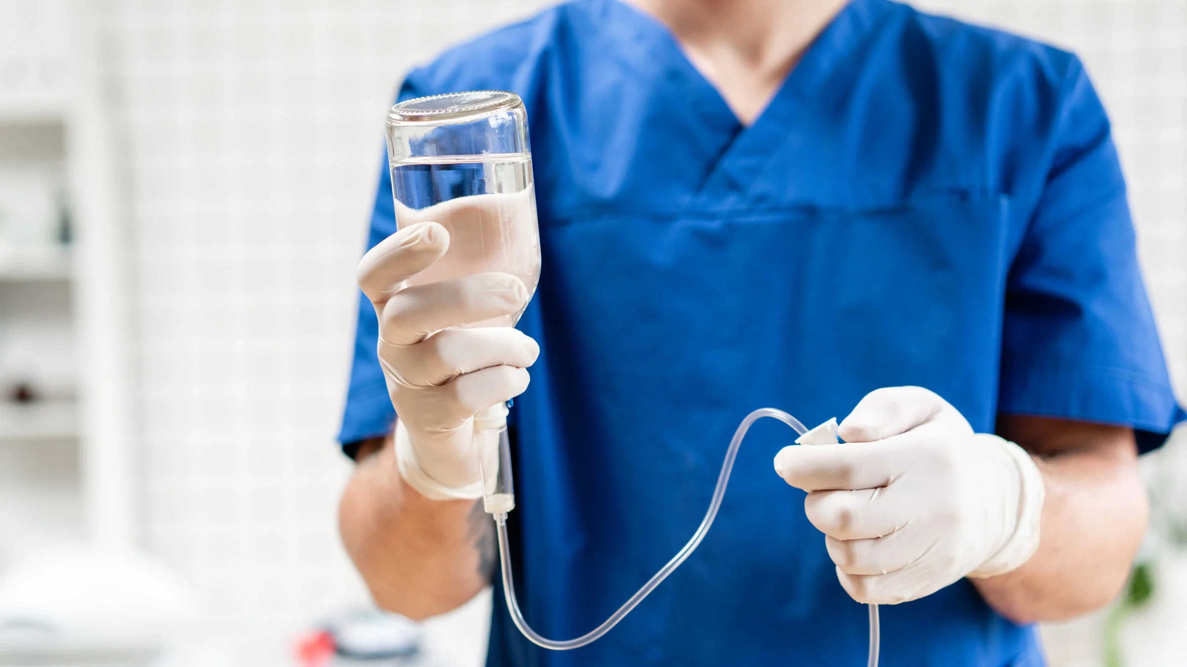 A doctor holding an IV infusion.