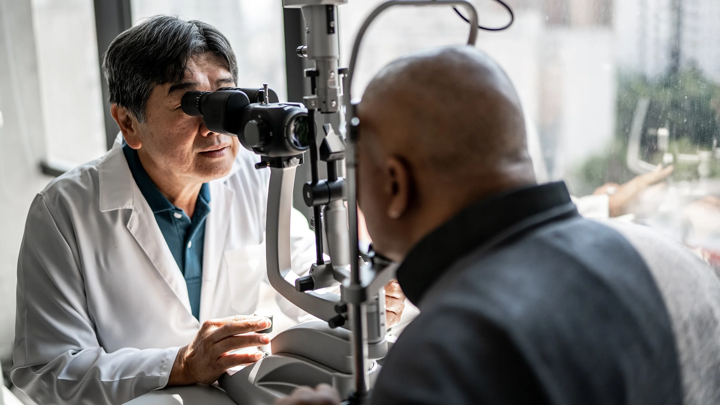 An ophthalmologist examines a man’s eyes. Some people may experience a dislocated lens after cataract surgery.