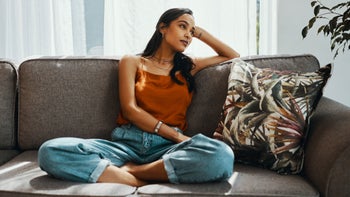 Women's Health: woman relaxing on sofa 1194601645