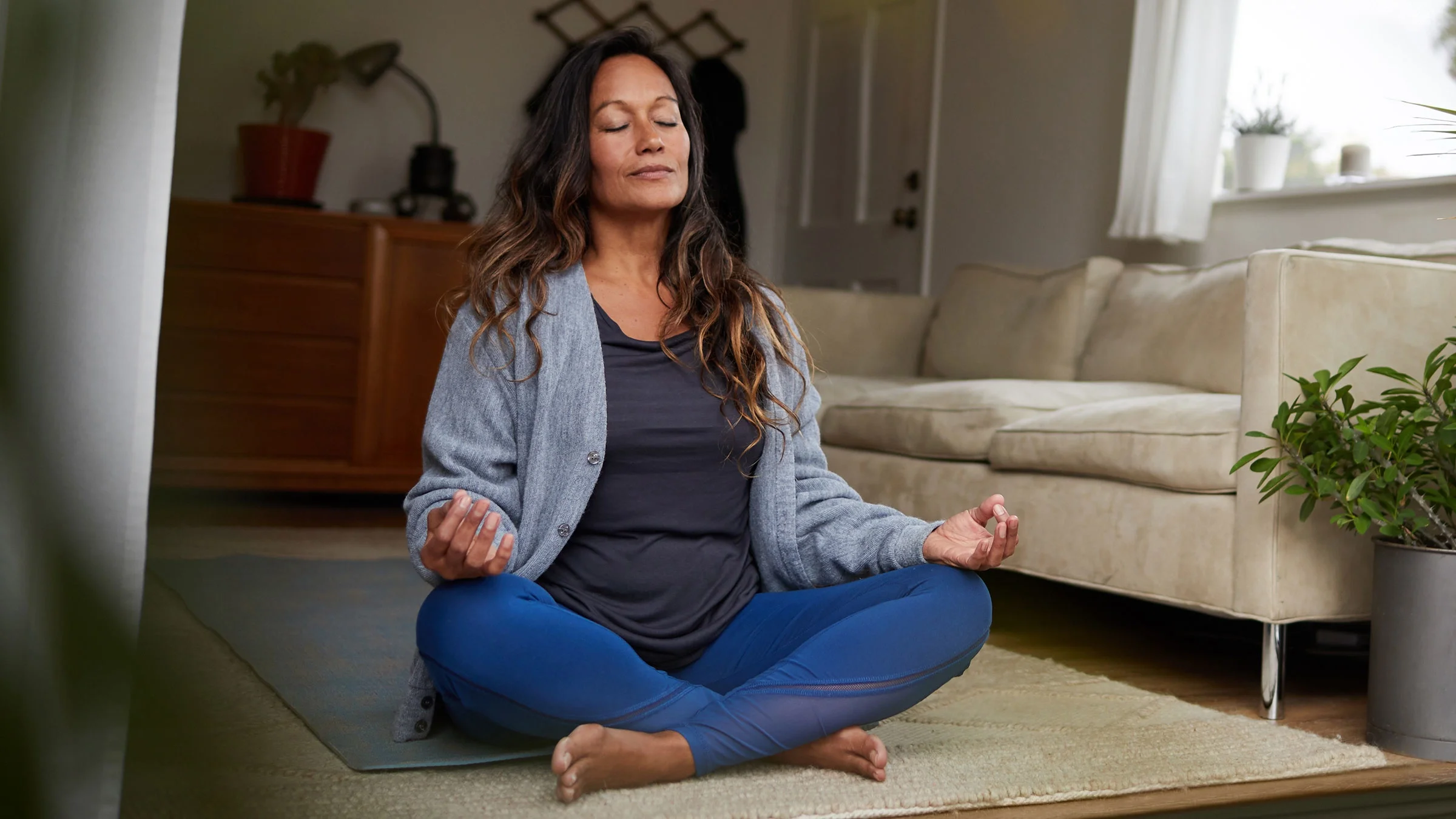 Woman meditating with a peaceful expression.