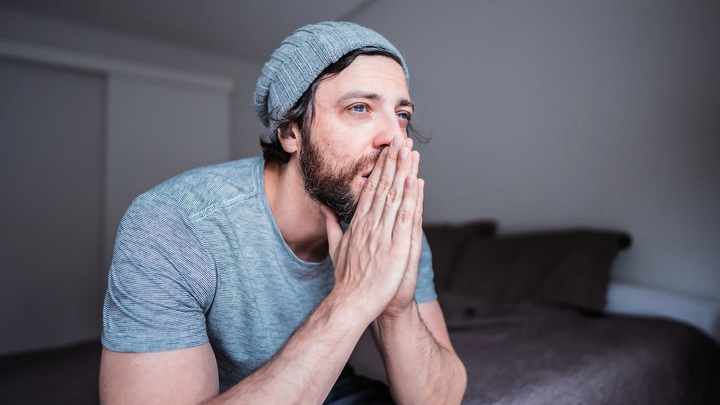 Sad and worried adult man at home.