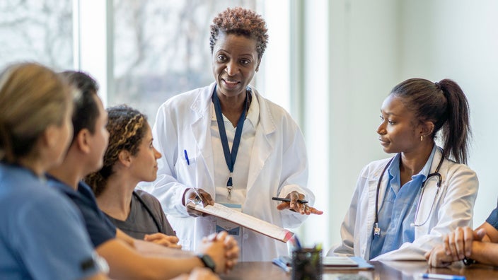 A nurse teaching medical students.