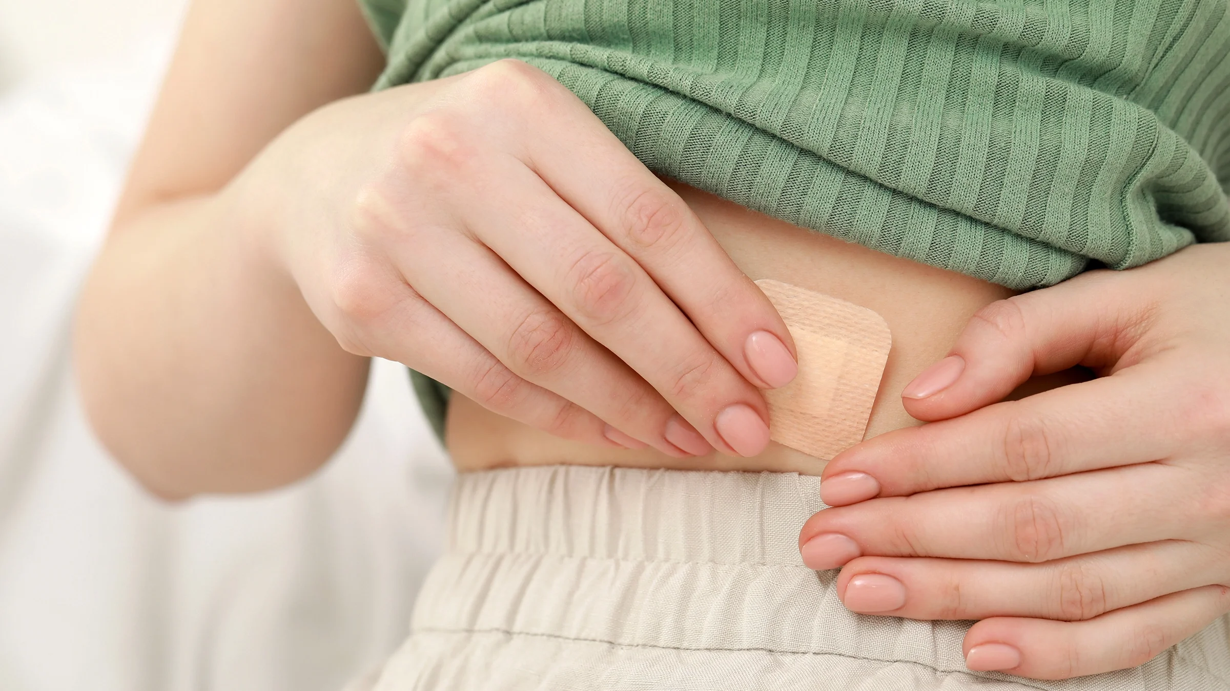 Close-up hormone patch on body.
