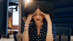 Close-up of a woman holding her head as if she has a headache.
PeopleImages/iStock via Getty Images
